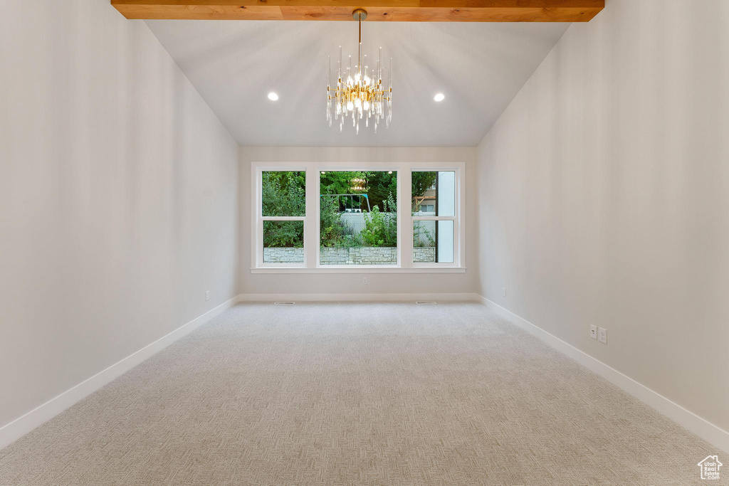 Unfurnished room with carpet flooring, a chandelier, and lofted ceiling with beams