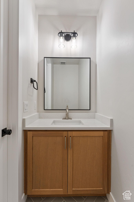 Bathroom featuring tile patterned flooring and vanity