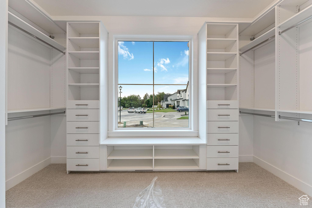 Spacious closet with light colored carpet