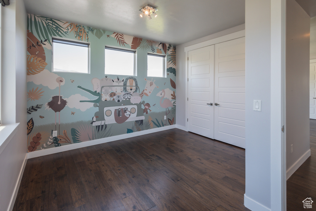 Spare room with dark wood-type flooring