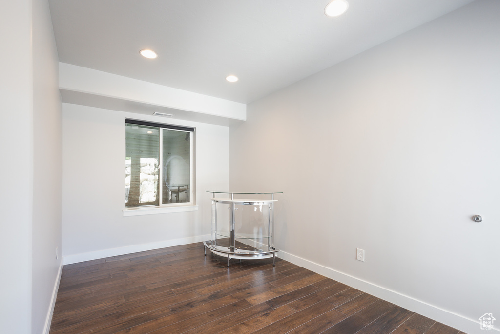 Empty room featuring dark hardwood / wood-style floors