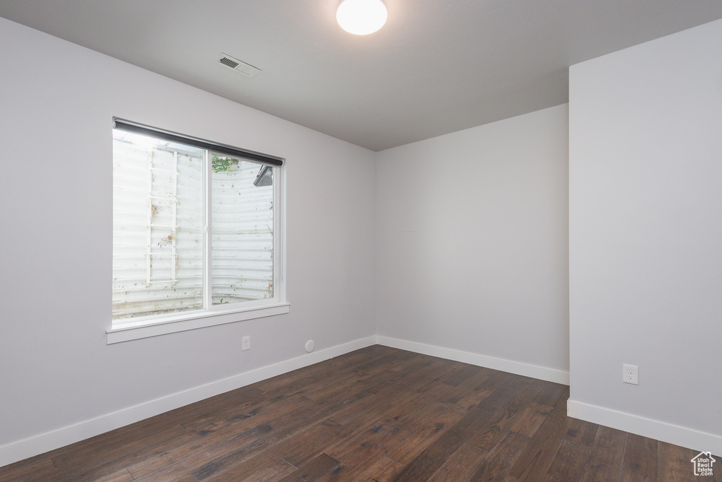 Spare room with dark hardwood / wood-style flooring