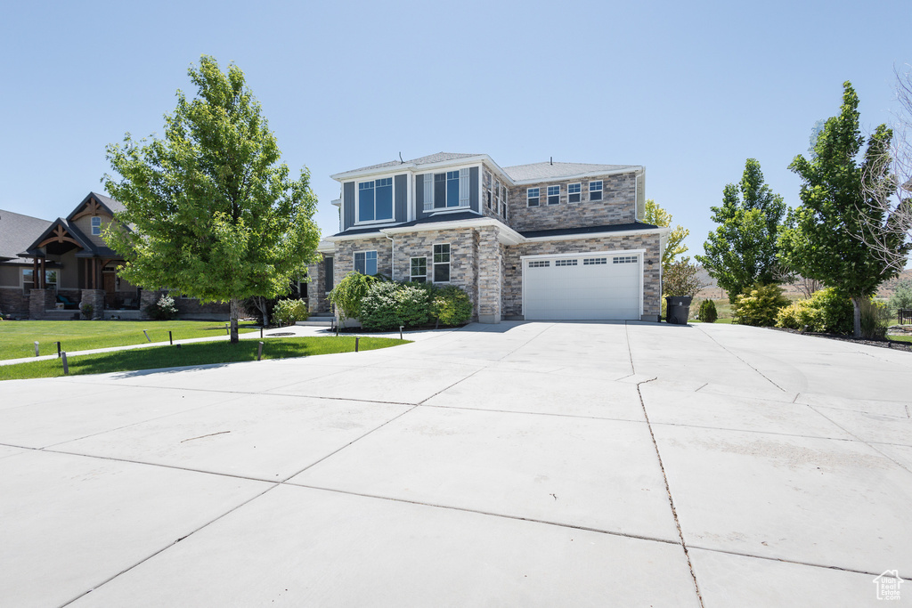 View of front of house with a front lawn and a garage