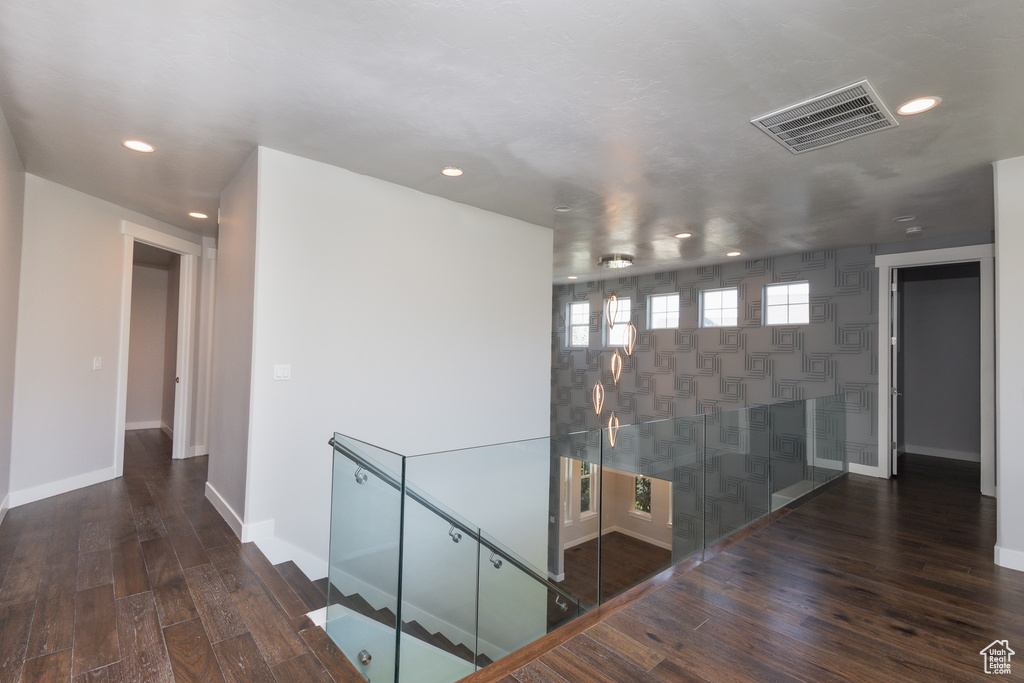 Corridor with dark hardwood / wood-style flooring