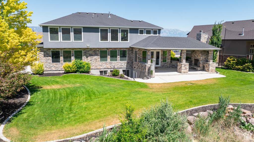 Back of house featuring a patio area and a lawn