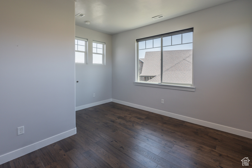 Unfurnished room with dark hardwood / wood-style floors