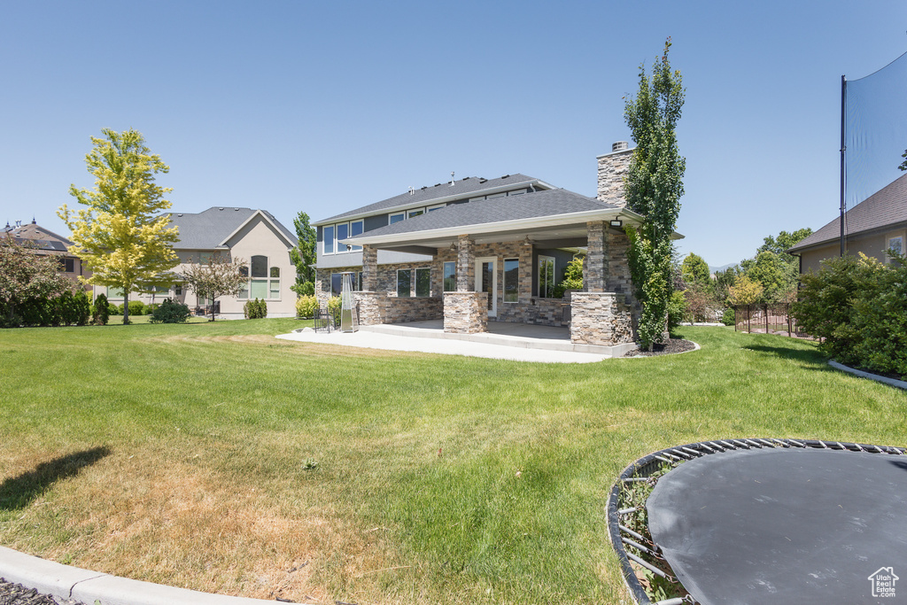 Back of house featuring a patio and a yard