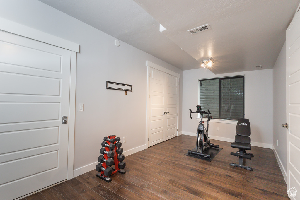 Exercise room with dark wood-type flooring