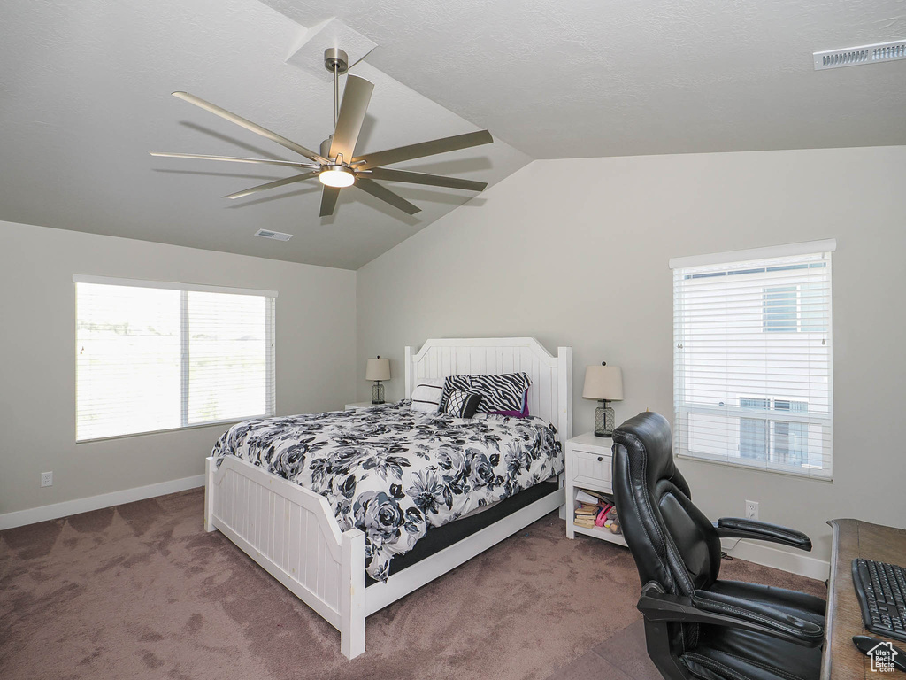 Bedroom featuring multiple windows, lofted ceiling, carpet, and ceiling fan