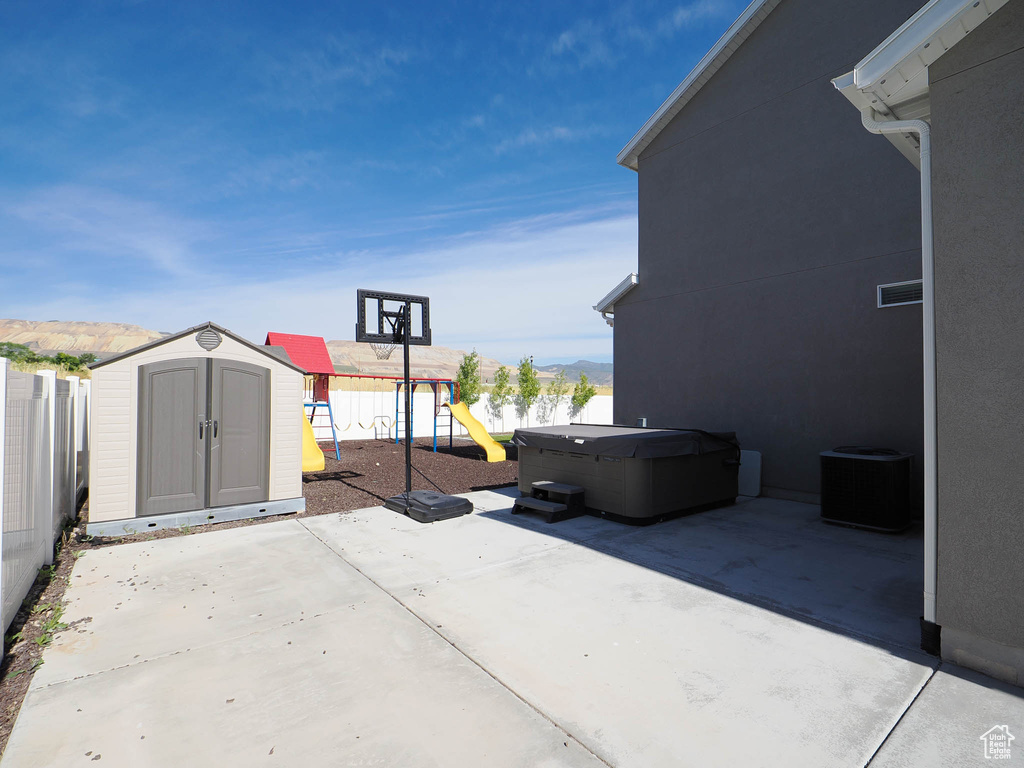 View of patio / terrace with a playground and a storage unit