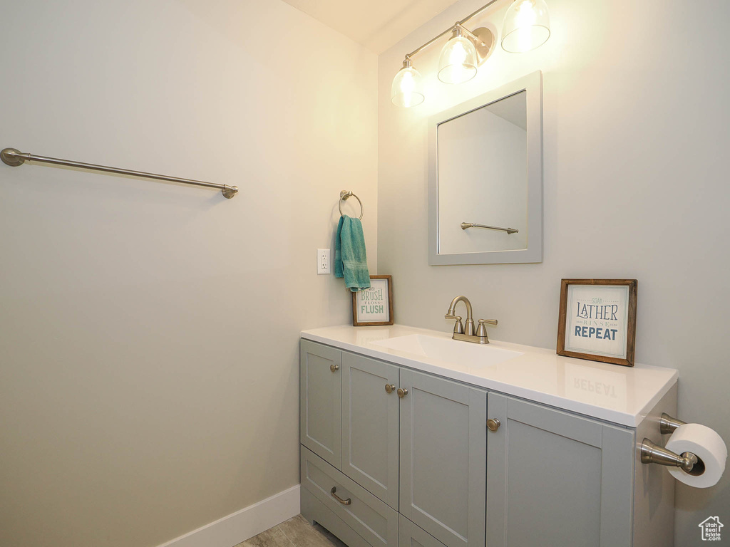 Bathroom with hardwood / wood-style flooring and large vanity