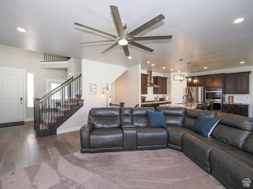 Living room featuring hardwood / wood-style floors and ceiling fan