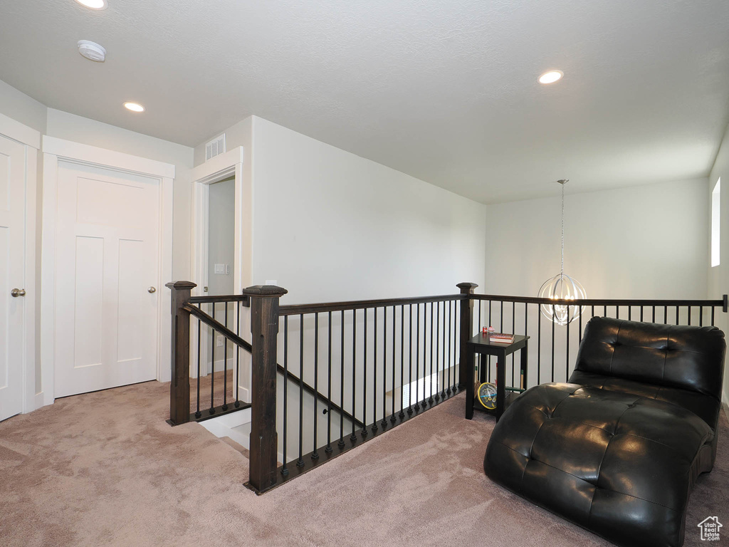 Living area featuring a chandelier and carpet