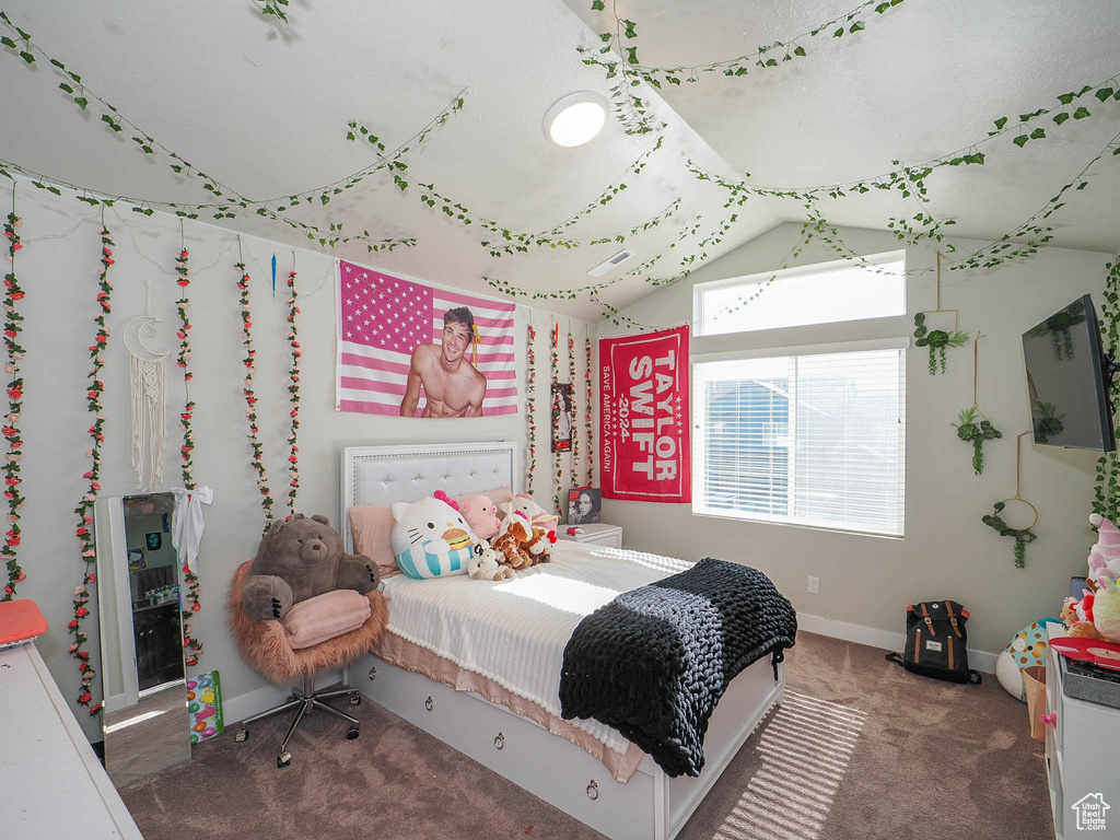 Bedroom featuring carpet flooring and vaulted ceiling