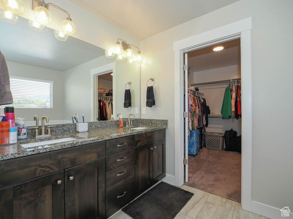 Bathroom with double sink vanity and tile floors