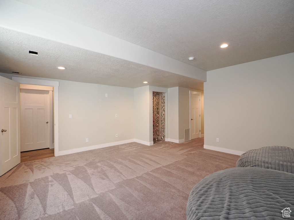 Carpeted bedroom with a textured ceiling