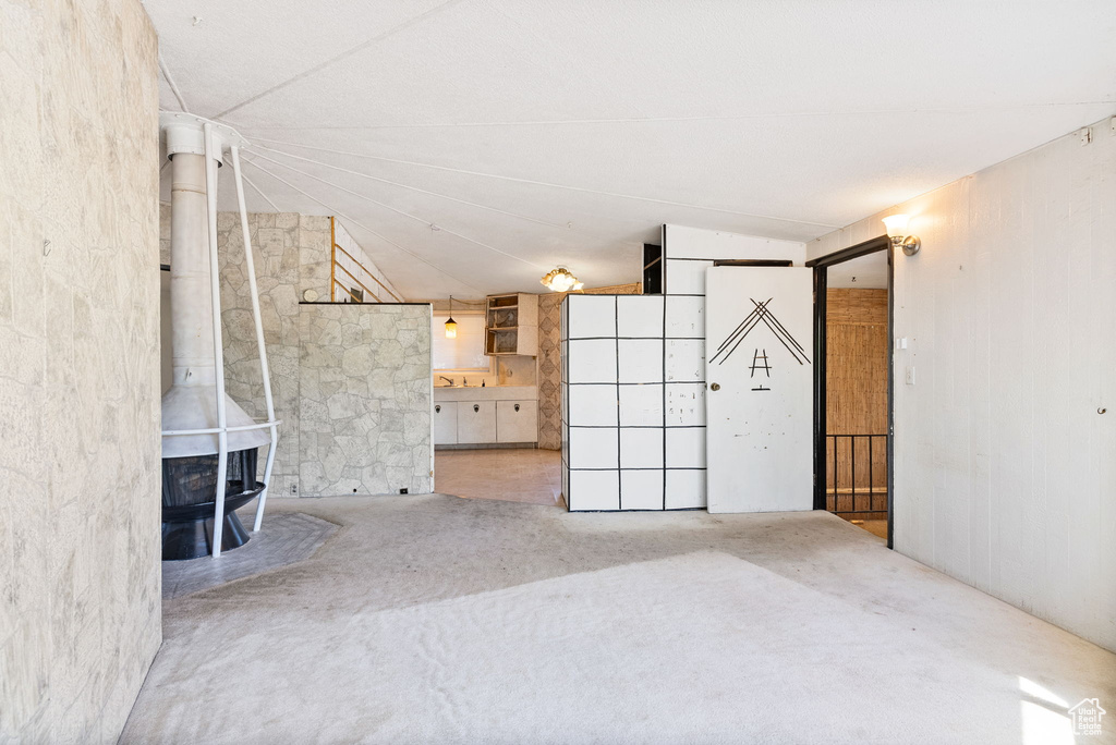 Unfurnished living room with a wood stove