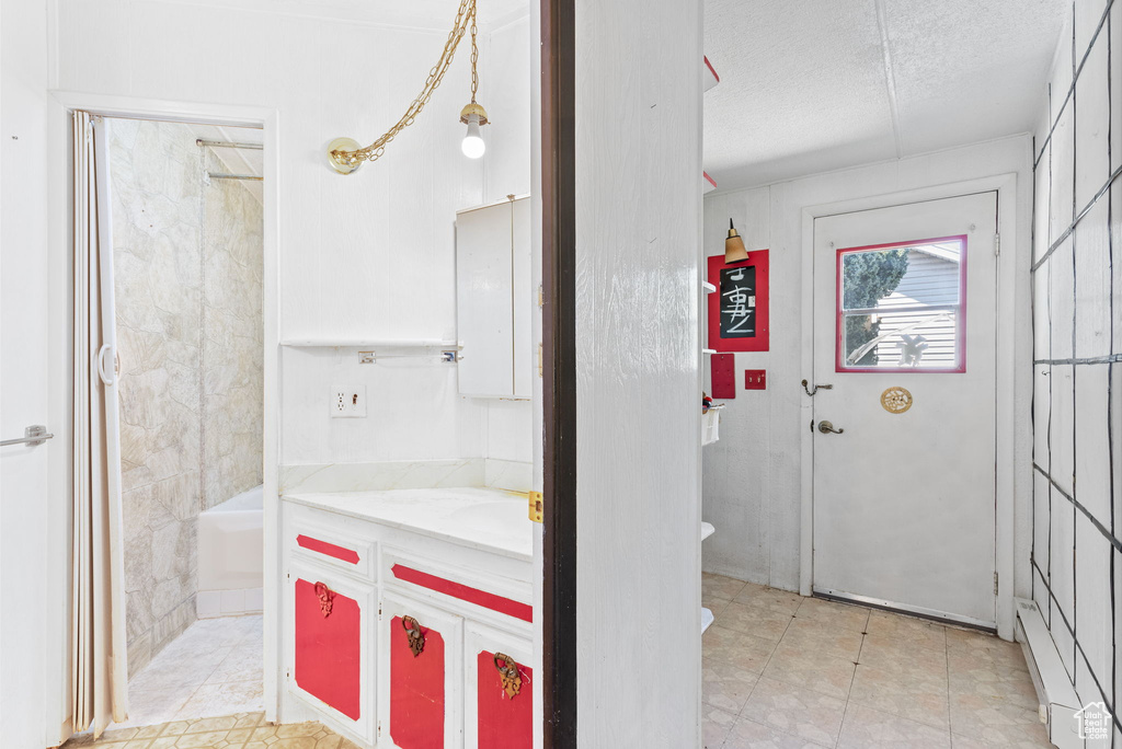 Full bathroom featuring tile flooring, a textured ceiling, shower / tub combination, vanity, and toilet