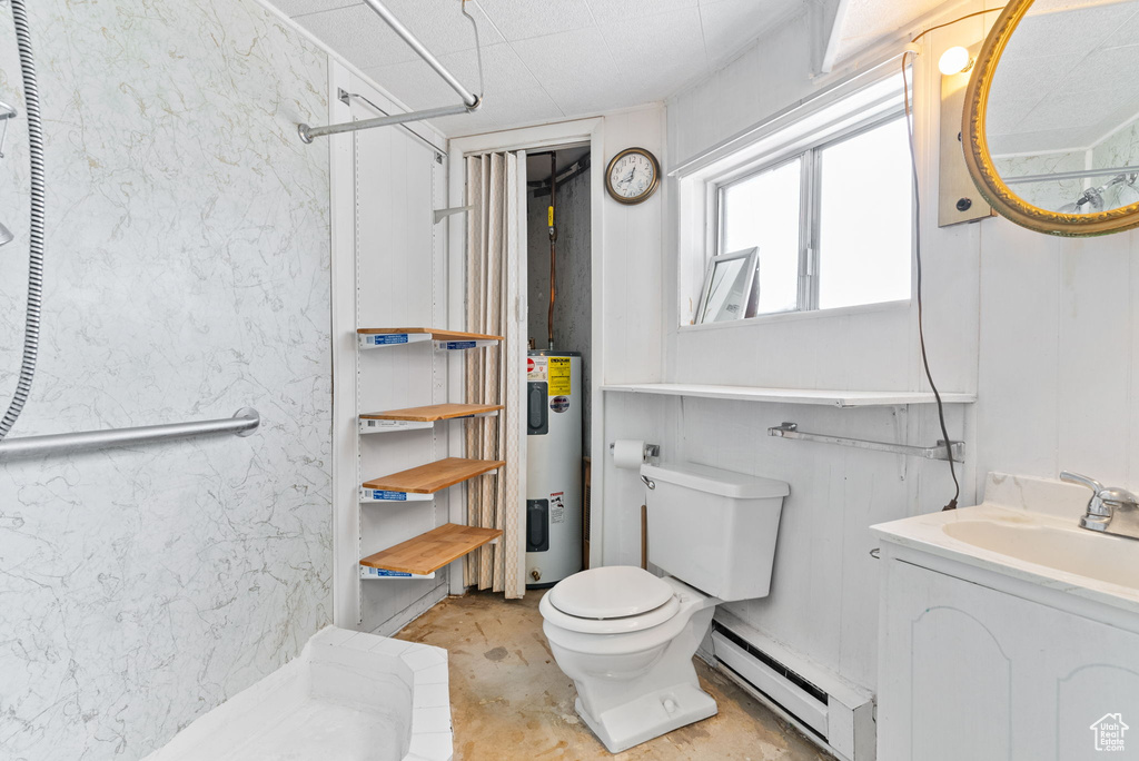 Bathroom with electric water heater, baseboard heating, toilet, and vanity