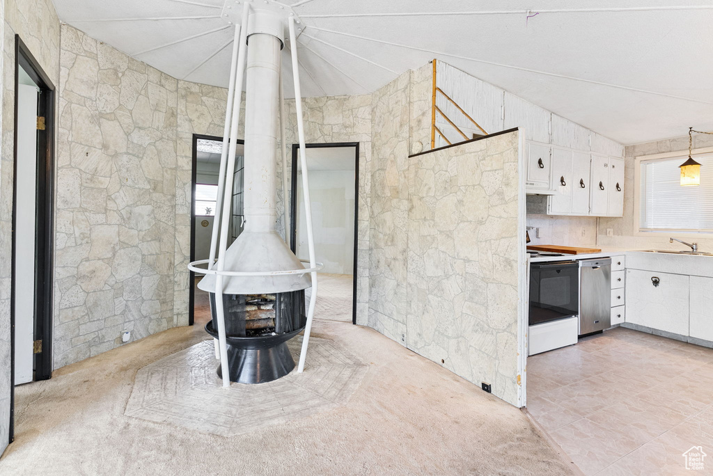 Kitchen with dishwasher, range, hanging light fixtures, sink, and white cabinets