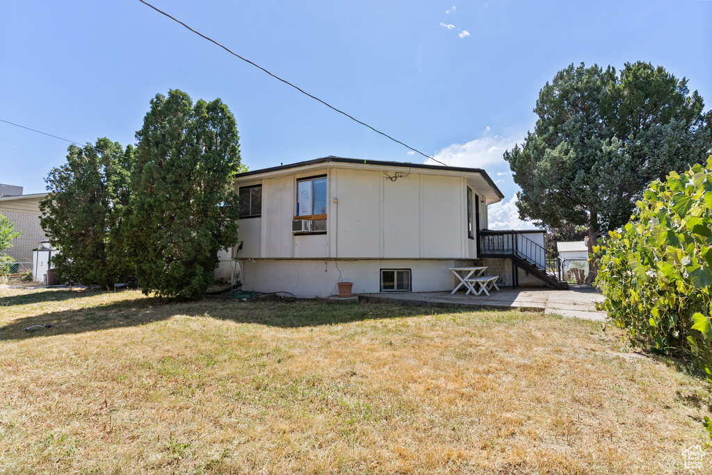 View of property exterior featuring a yard