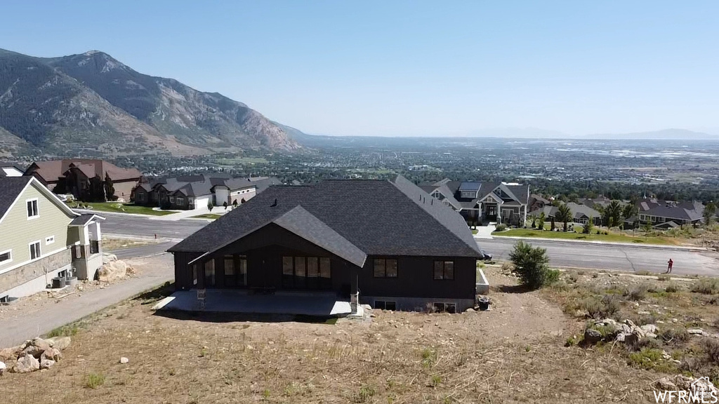 Rear view of house featuring a mountain view