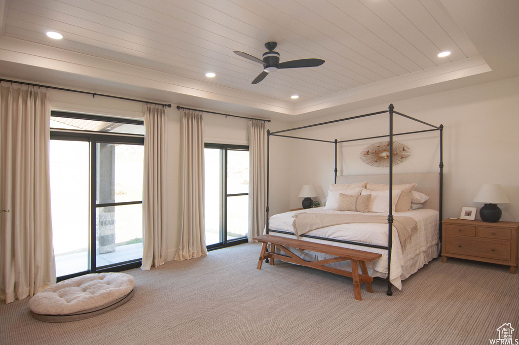 Bedroom featuring access to outside, carpet floors, multiple windows, and ceiling fan