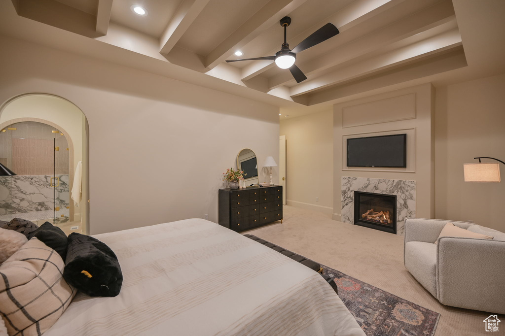 Carpeted bedroom with beamed ceiling, a high end fireplace, recessed lighting, and a ceiling fan