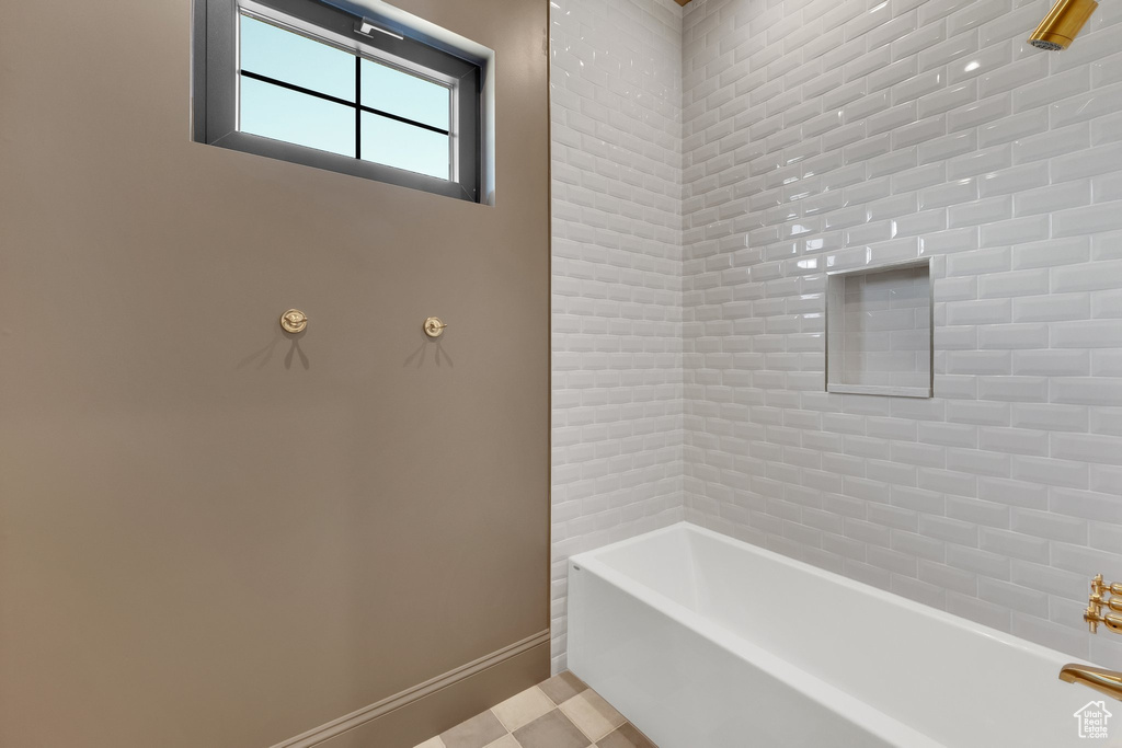 Full bath with baseboards and bathtub / shower combination
