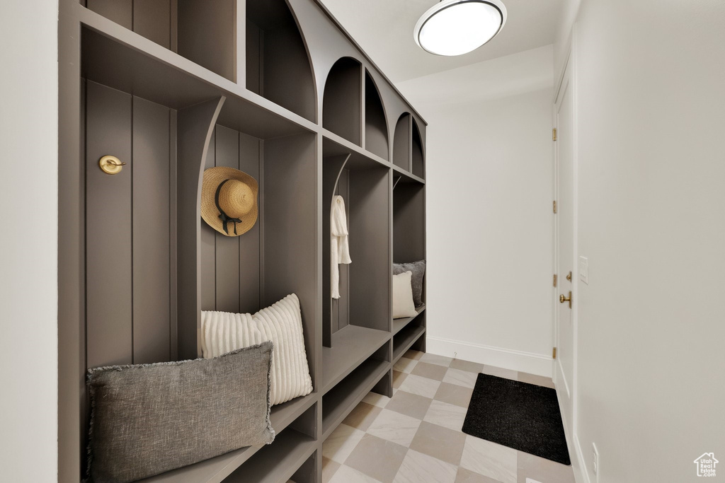 Mudroom with light flooring and baseboards