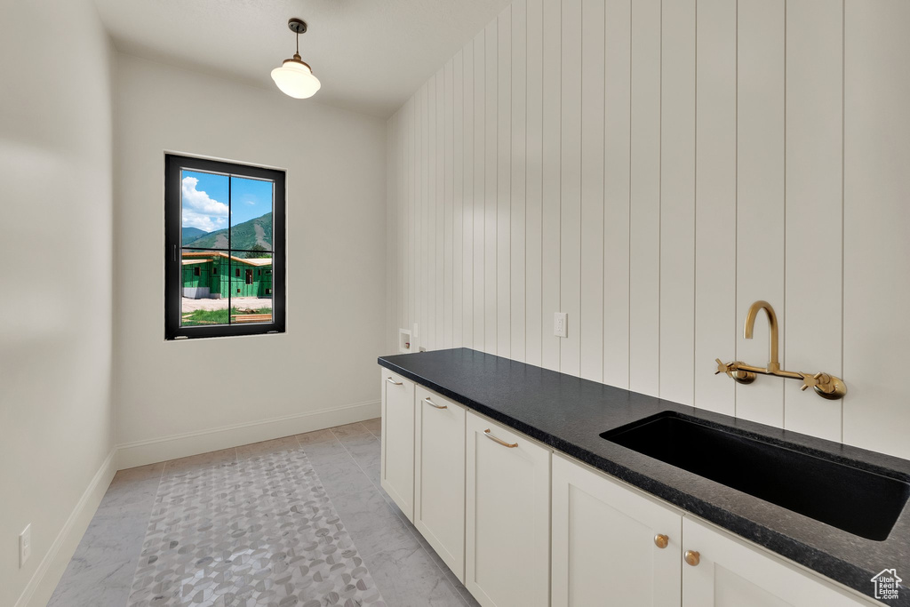 Laundry area featuring a sink and baseboards