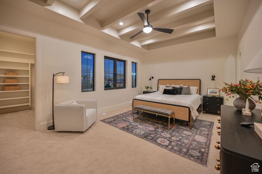 Carpeted bedroom with beamed ceiling, baseboards, and ceiling fan