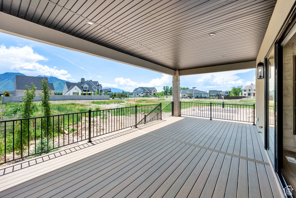 Deck with a residential view and a mountain view