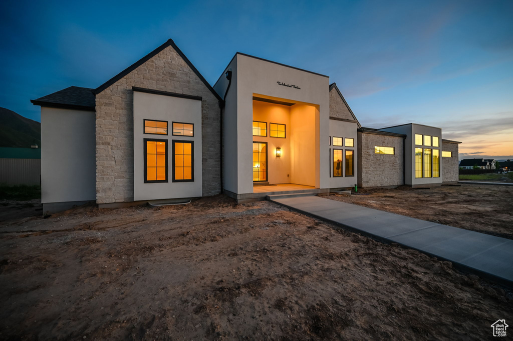 Contemporary home featuring stone siding and stucco siding