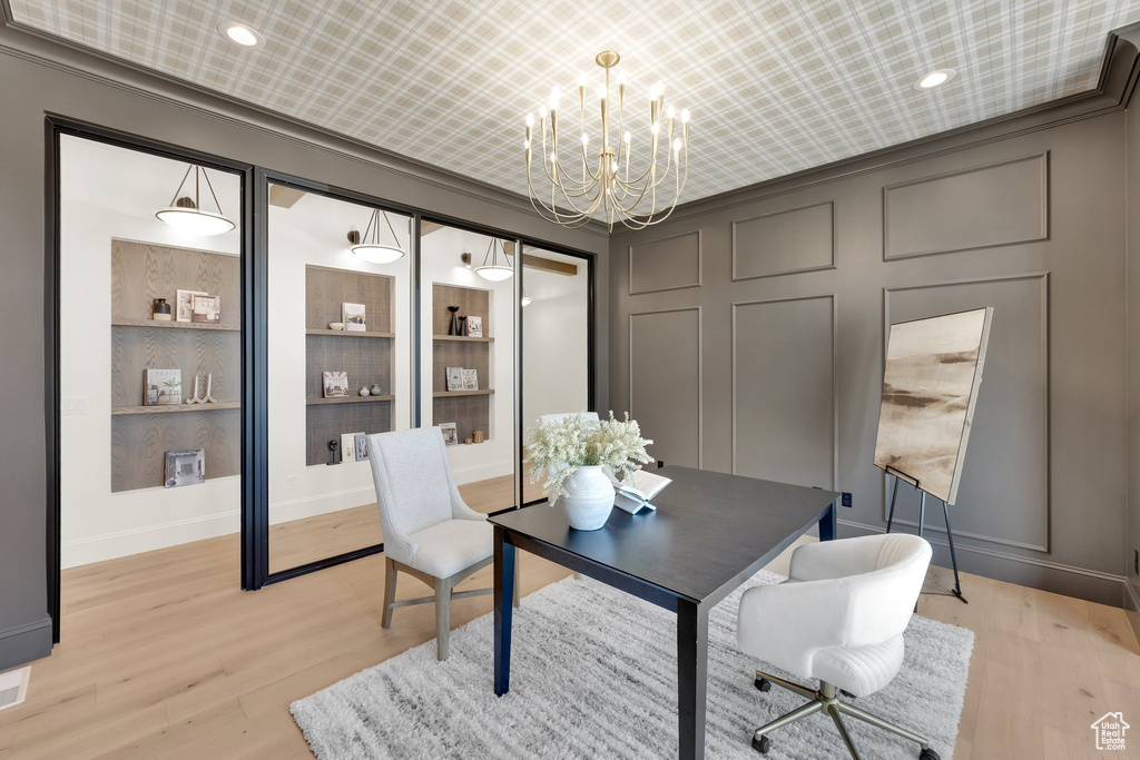 Office featuring a chandelier, light wood-style flooring, baseboards, recessed lighting, and a decorative wall