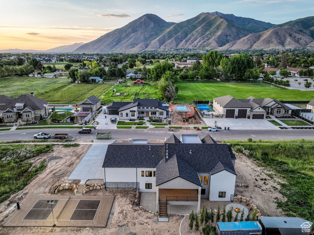 Aerial view of property and surrounding area with a mountainous background