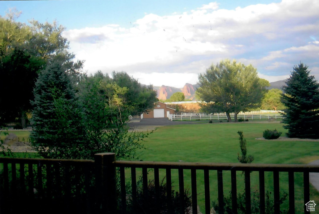 View of yard featuring a mountain view, an outdoor structure, and a rural view