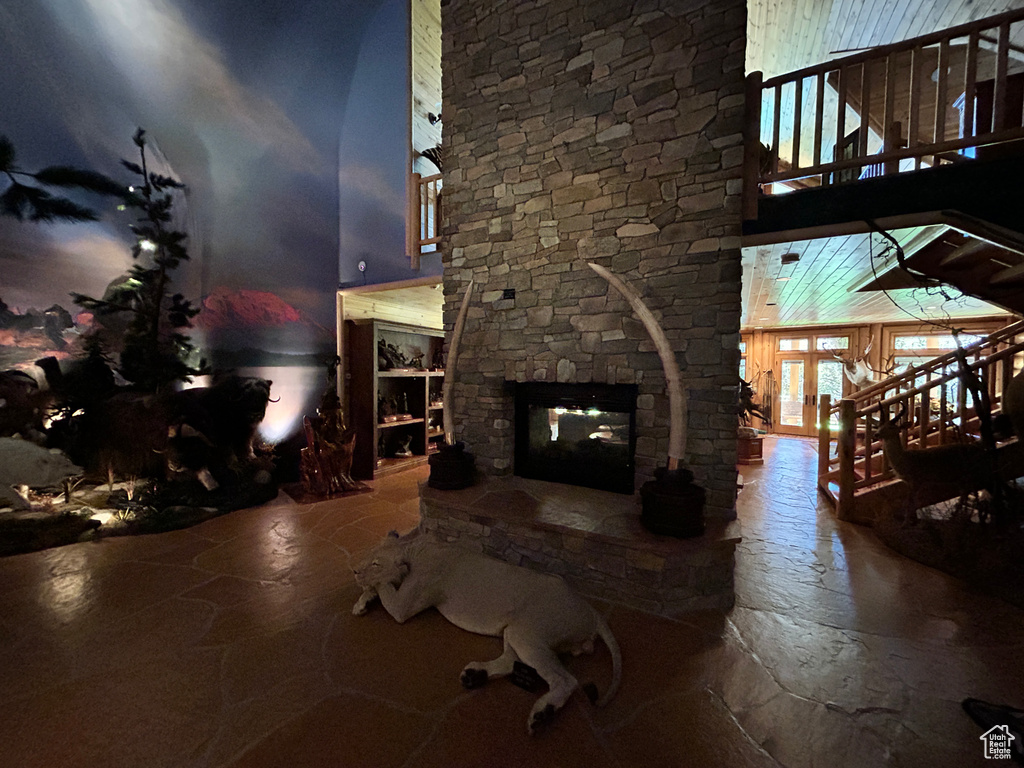 Living room with a stone fireplace and french doors