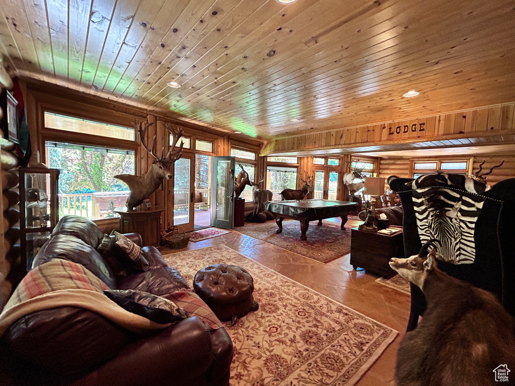Living room featuring tile flooring, billiards, french doors, and wood ceiling
