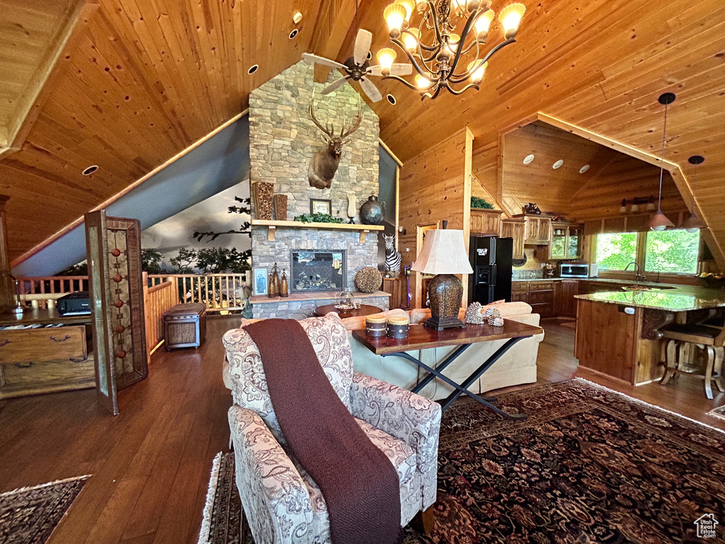 Living room with wooden ceiling, a fireplace, an inviting chandelier, and hardwood / wood-style floors