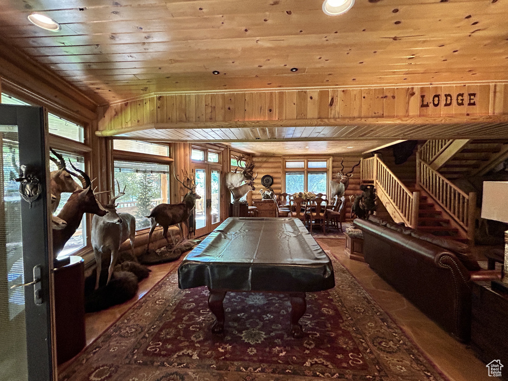 Game room featuring log walls, wooden ceiling, pool table, and french doors