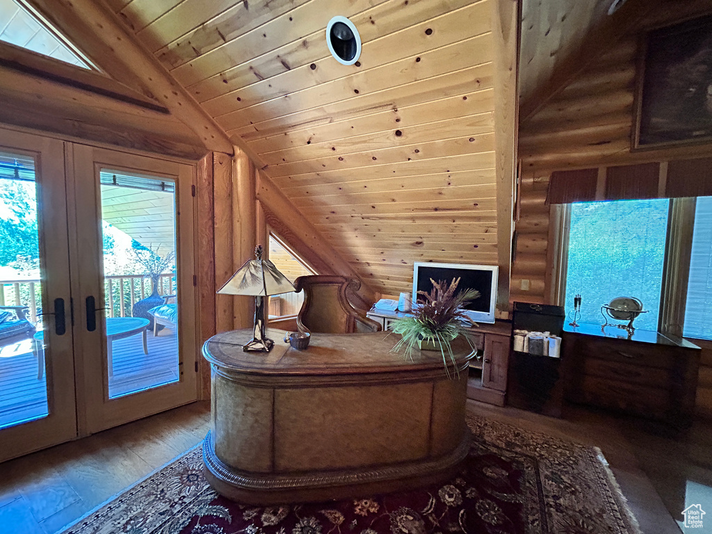 Home office featuring french doors, wood ceiling, lofted ceiling, log walls, and hardwood / wood-style flooring