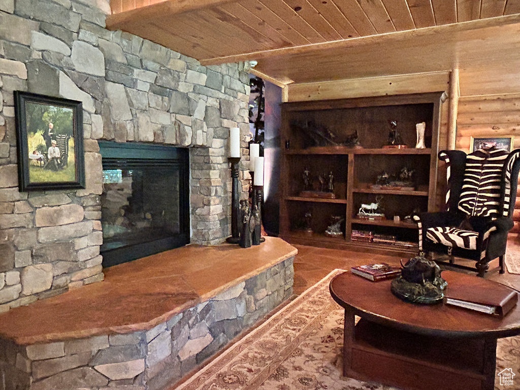Living room featuring a fireplace and wood ceiling