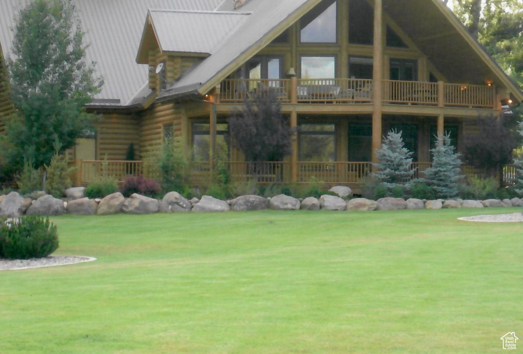 Back of house with a lawn