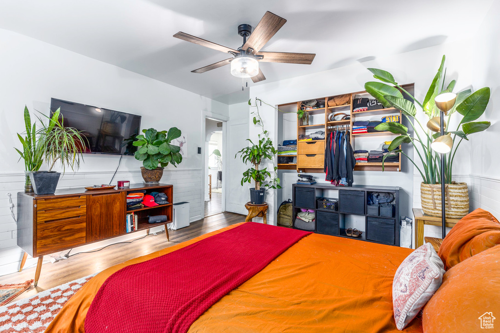 Bedroom featuring ceiling fan and wood-type flooring