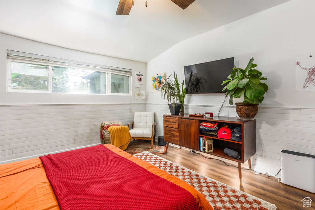 Bedroom featuring lofted ceiling, wood-type flooring, and ceiling fan