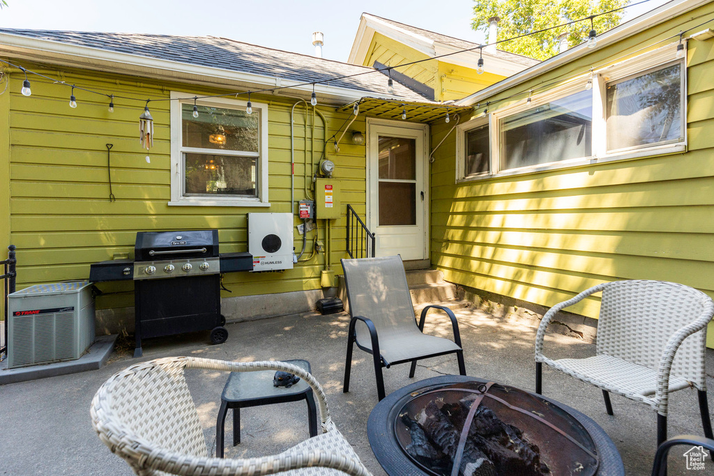 View of patio featuring an outdoor fire pit and area for grilling