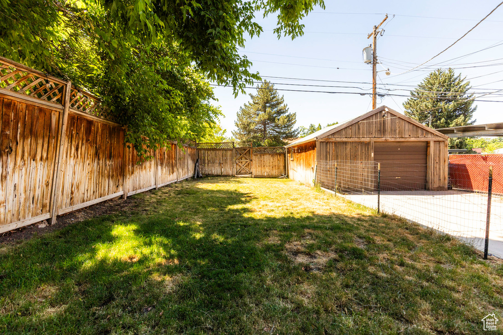 View of yard with a garage and an outdoor structure