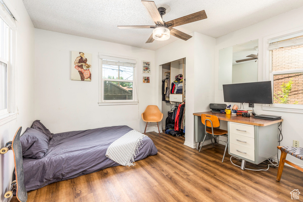 Bedroom featuring ceiling fan, a closet, and wood-type flooring