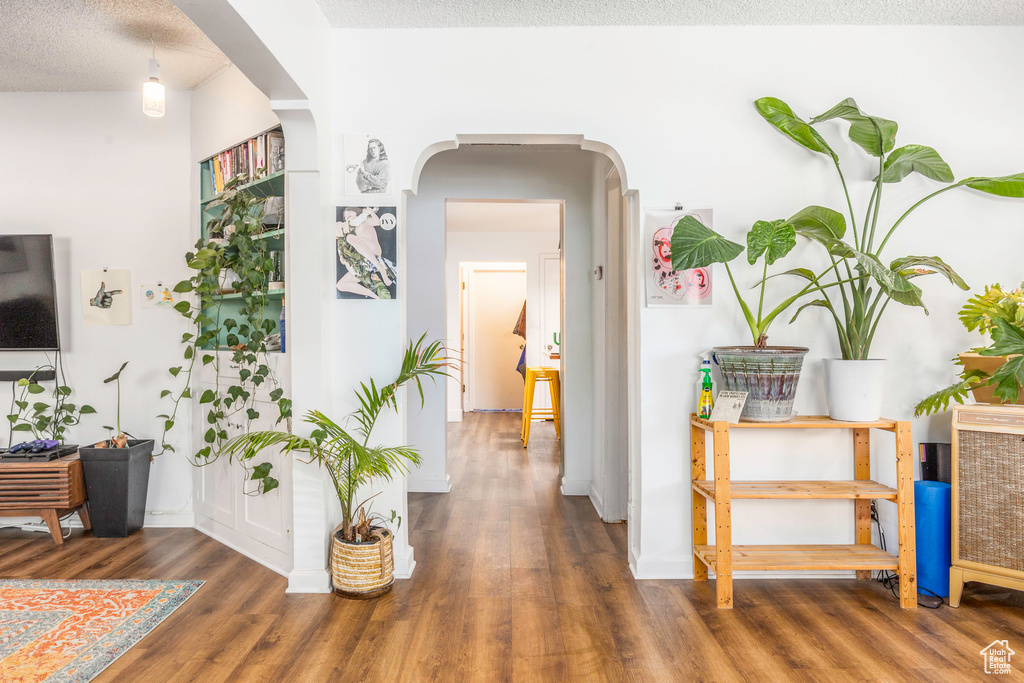 Hallway featuring hardwood / wood-style flooring and a textured ceiling